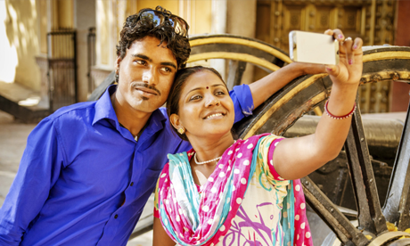 An ethnic couple taking a selfie